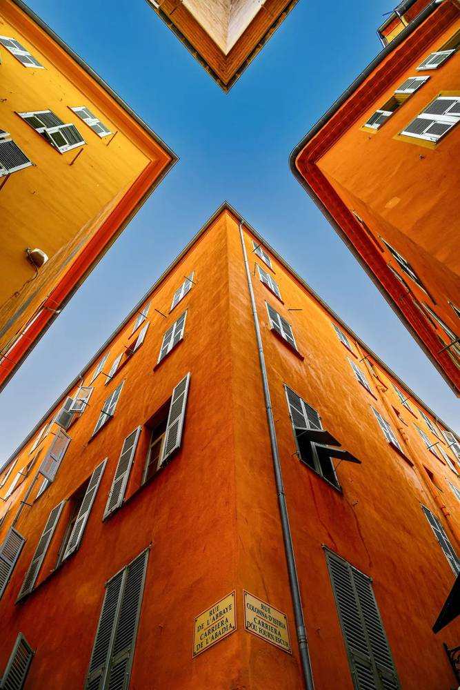 Orange buildings rising against a blue sky